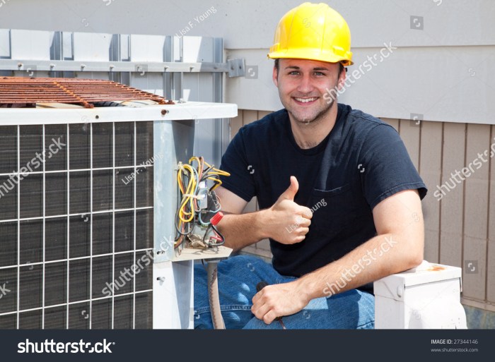 Air Conditioning Repairman Working On A Compressor And Giving A ...