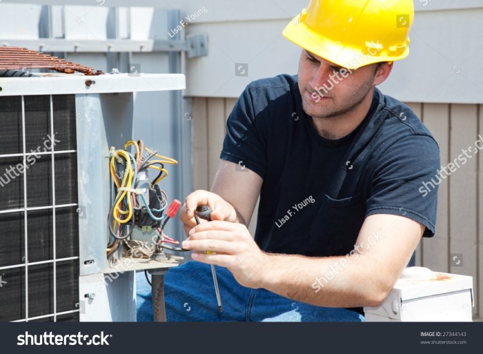 Young Repairman Fixing An Industrial Air Conditioning Compressor. Stock ...